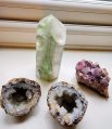 A small collection of crystals on my windowsill, including a geode