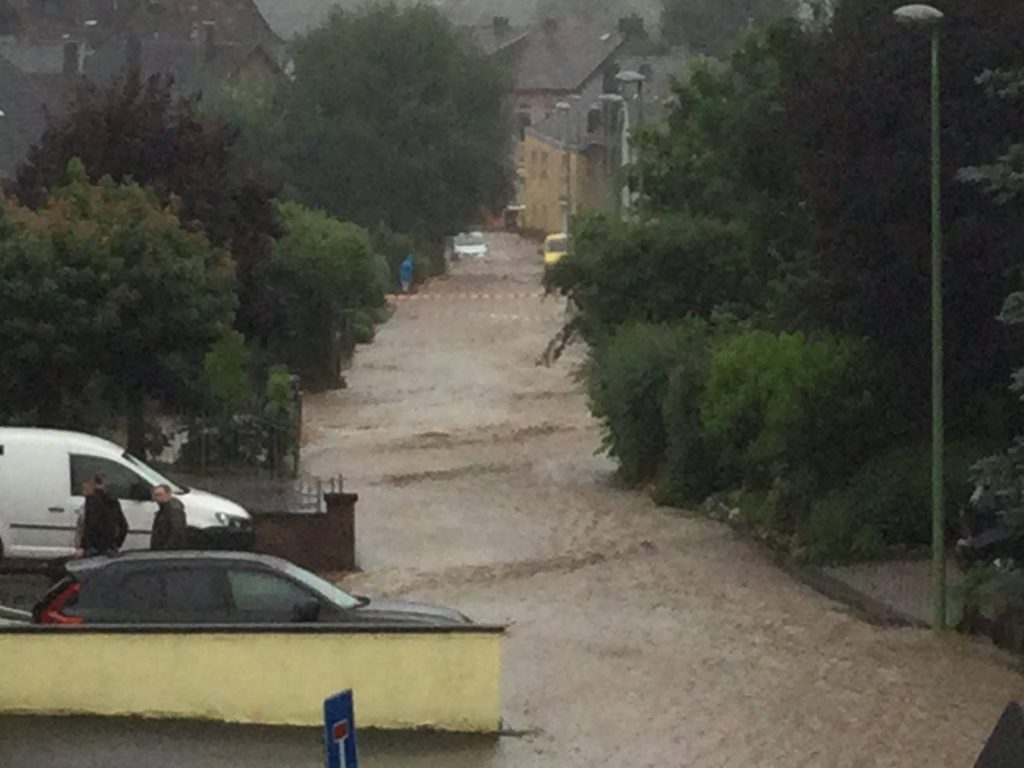 a street has become a stream during the 2021 German floods - view from my parents' window in Stolberg